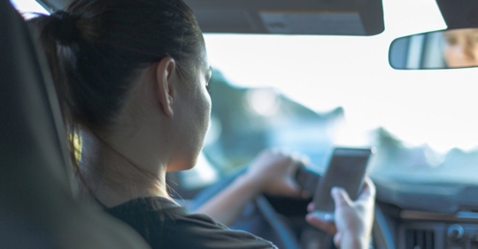 teen driver looking at phone